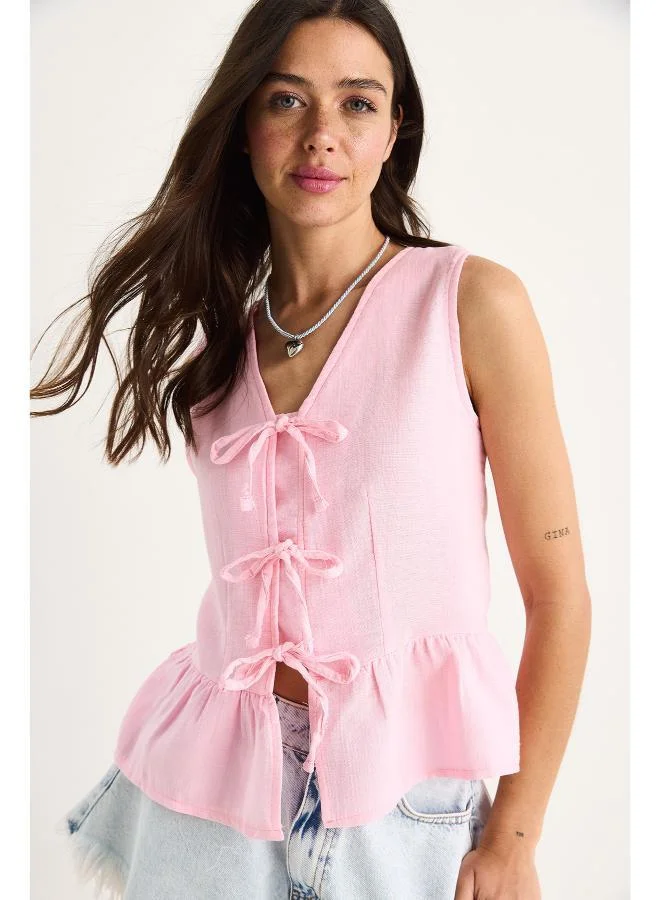 Ginger Bow Tie Up Detail Peplum Top